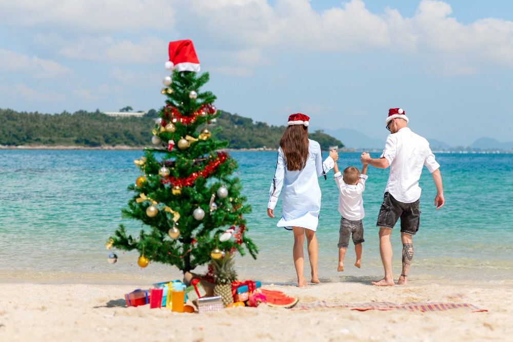 Young family having a break from their business at Christmas on the beach
